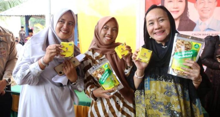 Calon Bupati Kabupaten Musi Banyuasin, Hj. Lucianty, bersama Santriwati Pondok Pesantren Izzatul Kamilah, memperlihatkan cemilan Dodol yang diberi nama Dowitul, hari Sabtu, tanggal 9 November 2024. (foto : detiksumsel.com)