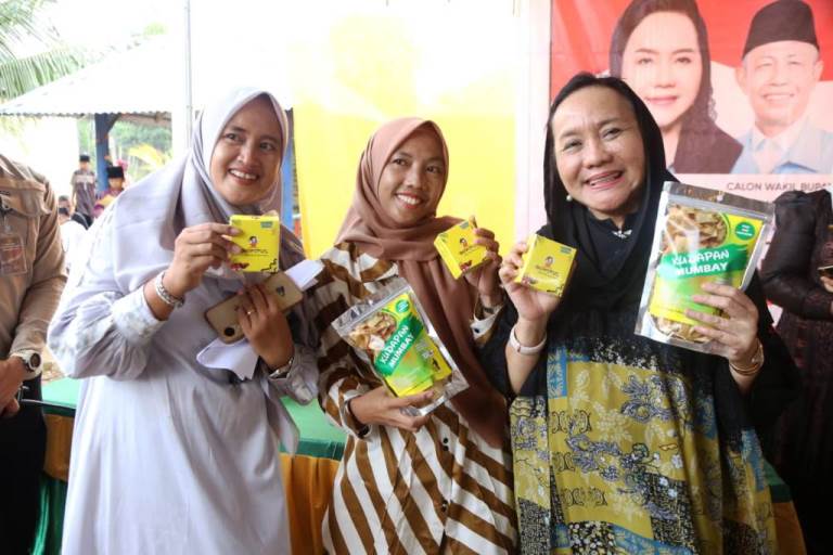 Calon Bupati Kabupaten Musi Banyuasin, Hj. Lucianty, bersama Santriwati Pondok Pesantren Izzatul Kamilah, memperlihatkan cemilan Dodol yang diberi nama Dowitul, hari Sabtu, tanggal 9 November 2024. (foto : detiksumsel.com)
